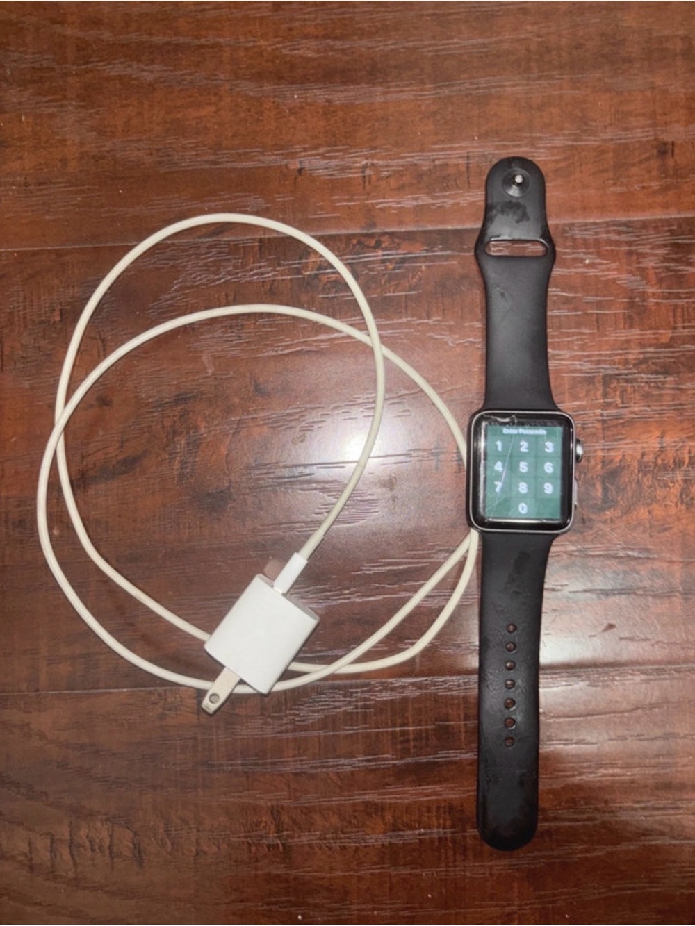Black Smartwatch with Black Silicone Band and Charger